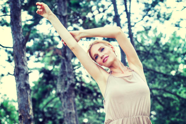istock Young beautiful happy woman in park 668540844