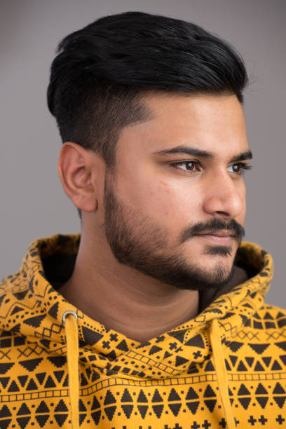 istock Face of young handsome Indian man thinking 668540890