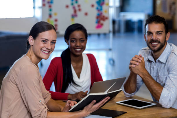 istock Colleagues sitting at their desk 668540918