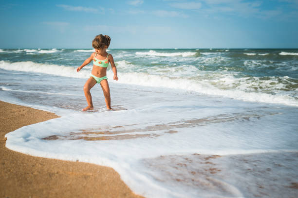 Kid having fun in water outdoors. 