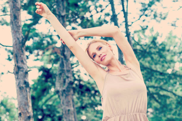 istock Young beautiful happy woman in park 668540984