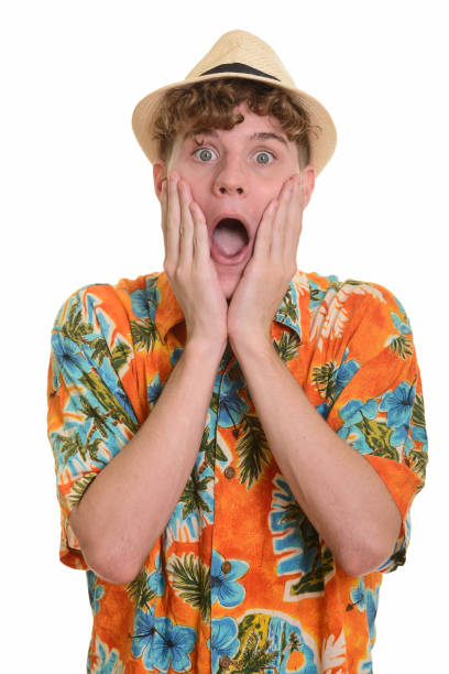 istock Young handsome man wearing hat while looking shocked ready for vacation 668547664