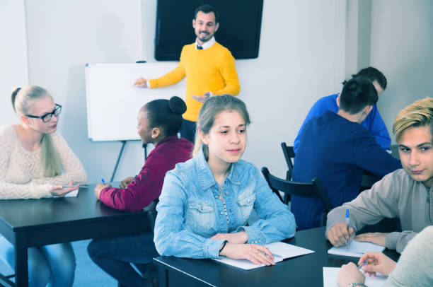 istock Young female and male students are working in large groups 668550130
