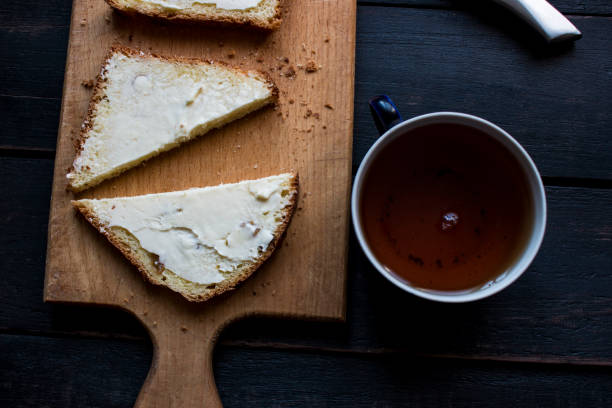 istock Tea with sandviches on wooden table 668551394