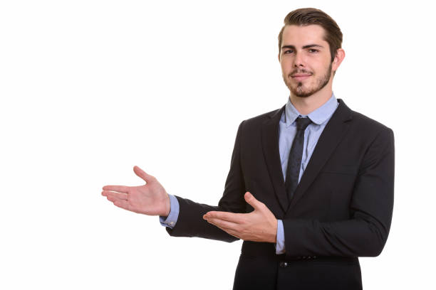 istock Young handsome businessman showing something 668551478
