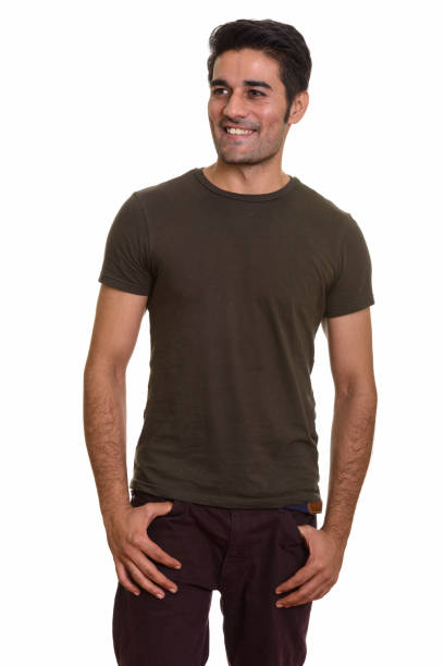 istock Young happy Persian man smiling and standing while thinking 668554984