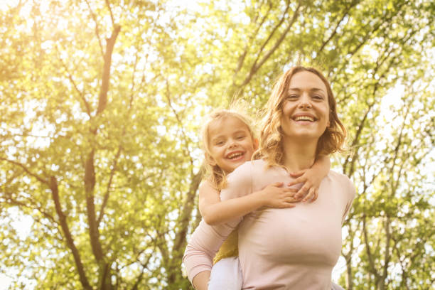 istock Mother and daughter outdoors in a meadow. 668557276
