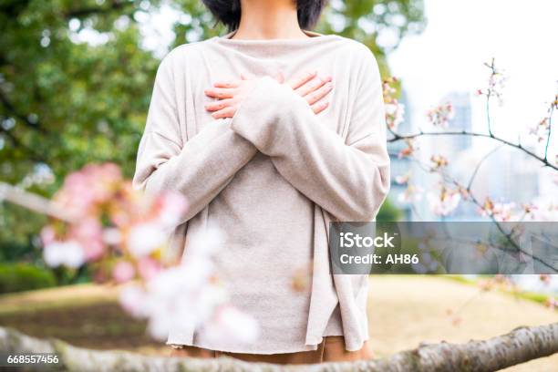 Woman And Cherry Blossom Stock Photo - Download Image Now - Holding Breath, Breathing Exercise, Inhaling