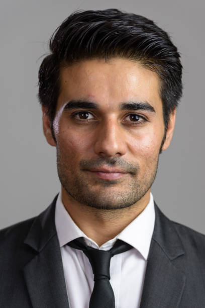 istock Face of young handsome Persian businessman 668557532