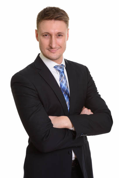 istock Handsome businessman with arms crossed against white background 668560682