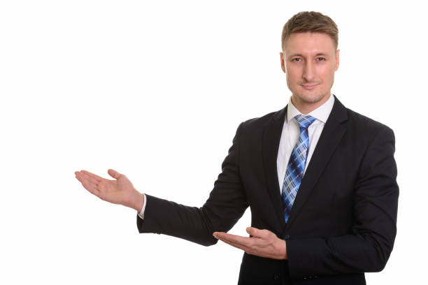 istock Studio shot of handsome businessman showing something 668560864