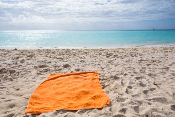istock Orange towel on beatiful tropical beach 668561860