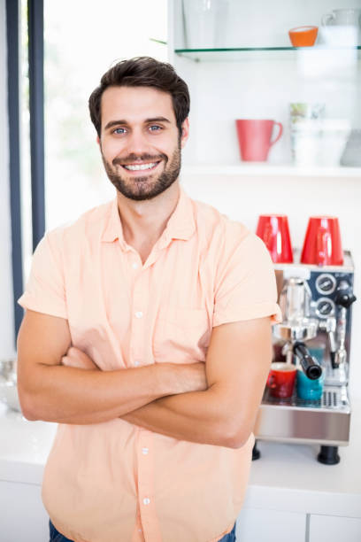 istock Man with arms crossed smiling at camera 668562098
