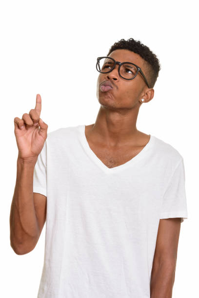 istock Young handsome African man pointing finger up while thinking and wearing eyeglasses 668565068