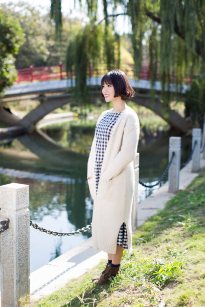 istock young style chinese girl standing lakeside 668566226