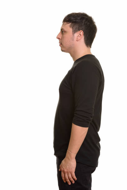 istock Profile view of man standing against white background 668568590