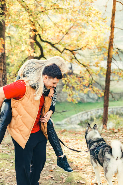 istock Young Smiling Couple Piggybacking During Autumn Day 668568974