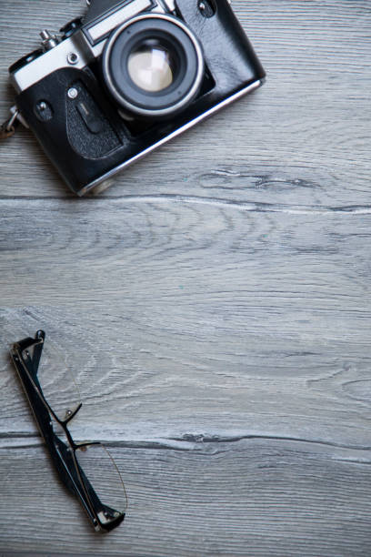 istock Travel - retro camera on vintage table. 668571804