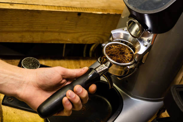 istock Barista grinds coffee beans in a coffee grinder. 668572016