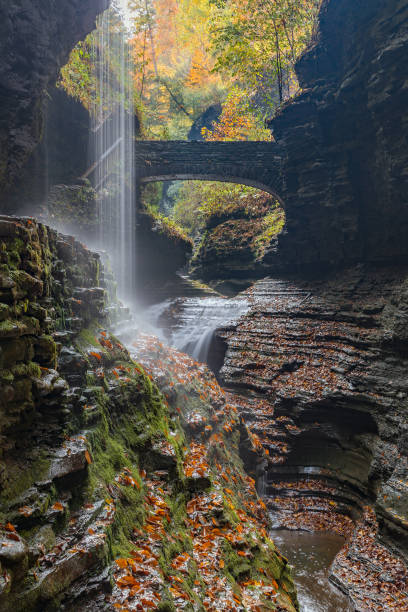 istock Beautiful waterfall cascade at Watkins Glenn state park, with autumn foliage colors 668575176
