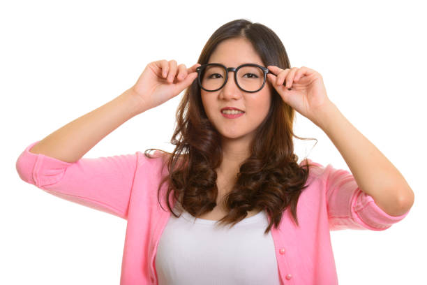 istock Young happy Asian woman smiling while holding eyeglasses 668581716