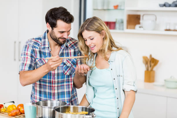 istock Young couple tasting food 668581760