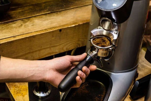 istock Barista grinds coffee beans in a coffee grinder. 668582354