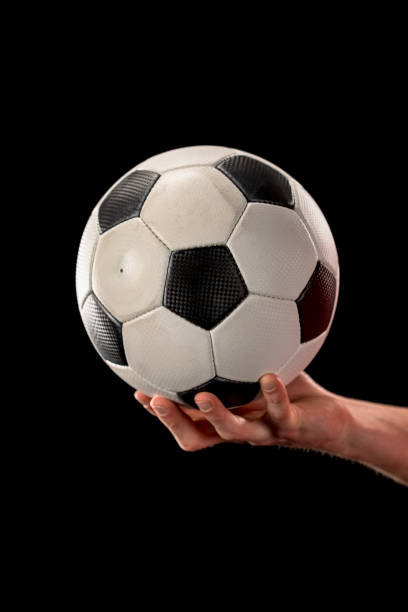 istock Soccer ball in hand 668582884