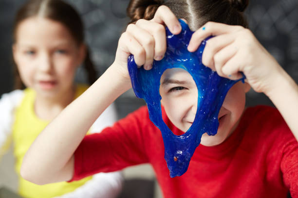 Slime peeking Happy kid looking through hole in blue slime slimy stock pictures, royalty-free photos & images
