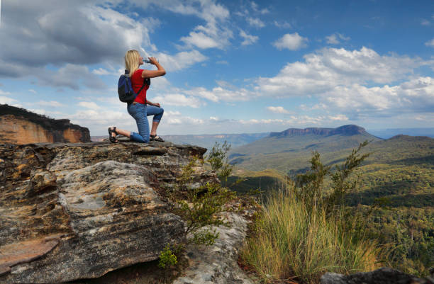istock Woman drinking water on mountain summit Australia 668589002