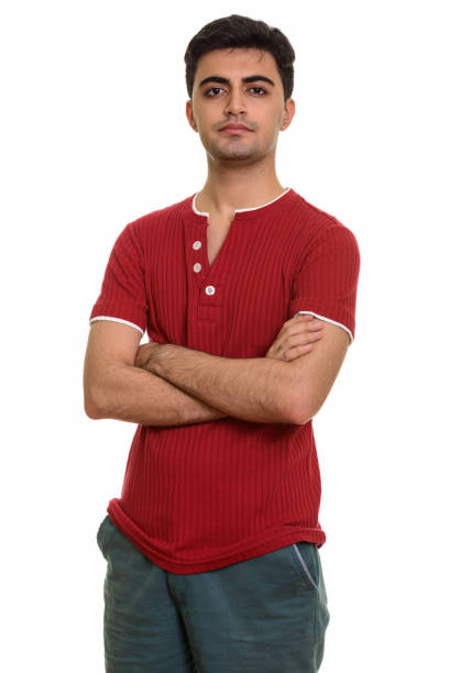 istock Young handsome Persian man standing with arms crossed 668595902