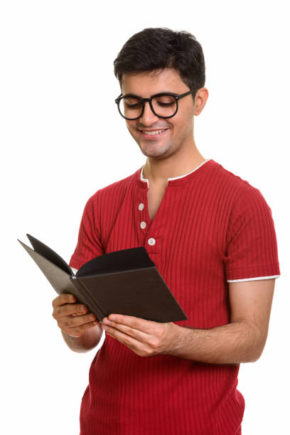 istock Young happy Persian man smiling while reading book and wearing eyeglasses 668596160