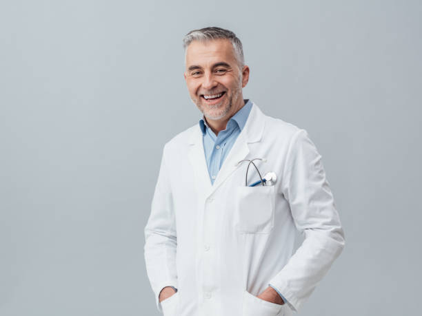 cheerful doctor posing - happy doctor imagens e fotografias de stock