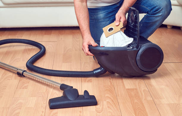 Replacement of a dust bag in vacuum cleaner stock photo