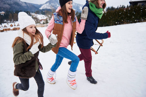 istock Close up of running parents with kid 668606568