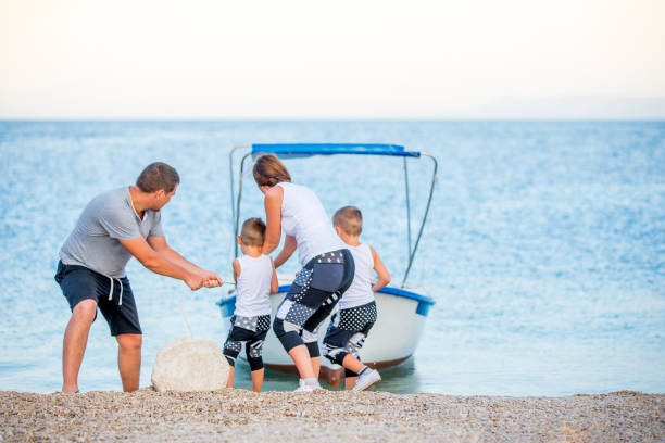 istock Young Family Enjoying Vacation on Seaside 668610274