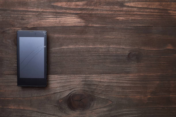 istock broken phone on a wooden background 668613152