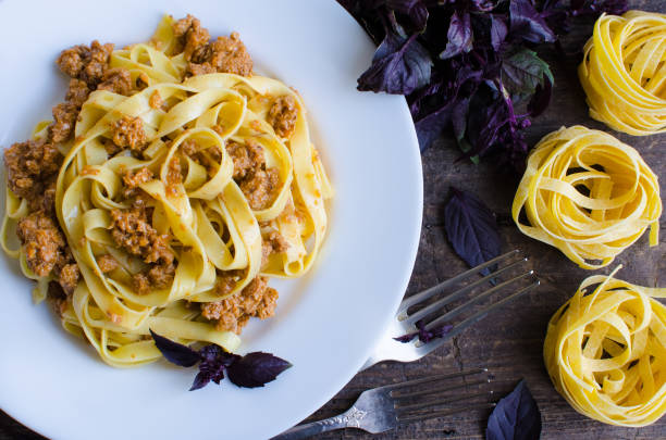 istock Pasta with bolognese sauce on wooden background 668613478