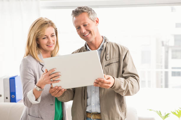 istock Casual business colleagues working with laptop 668613520