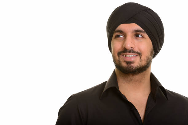 istock Close up of young happy Indian Sikh man smiling while thinking 668613706