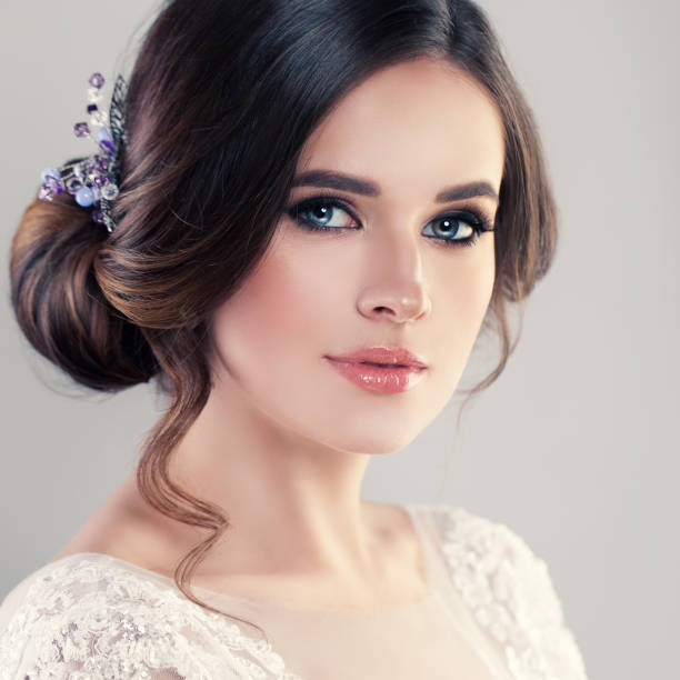 Young Woman Fiancee with Bridal Hairstyle, Natural Makeup and Jewelry Young Woman Fiancee with Bridal Hairstyle, Natural Makeup and Jewelry prom fashion stock pictures, royalty-free photos & images