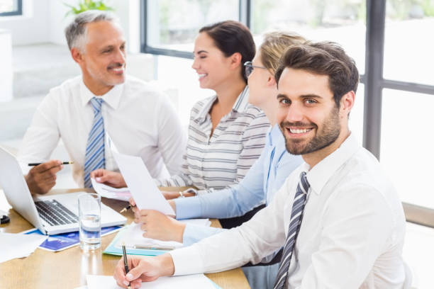 istock Businessman sitting with colleague while meeting 668617394