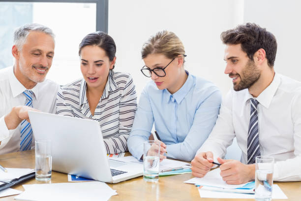 istock Business colleagues discussing office work on laptop 668617510