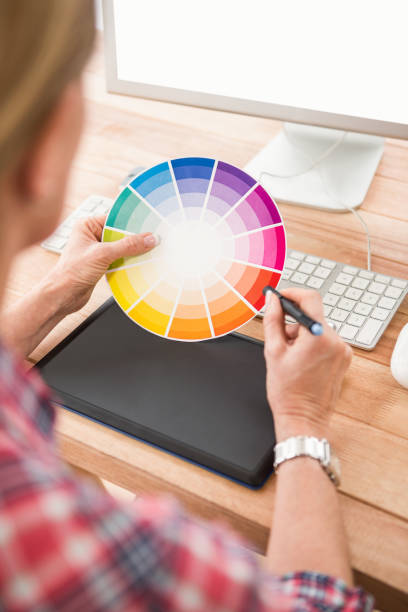 istock Casual designer working with digitizer and colour chart 668617516
