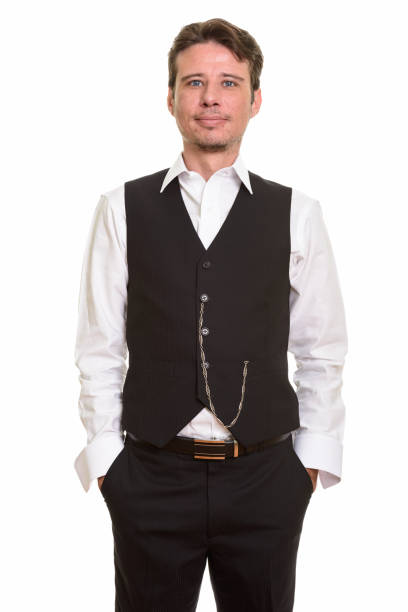 istock Handsome formal businessman standing with hands in pockets 668618322