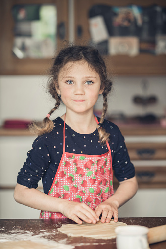 young girl baking in a kitchen