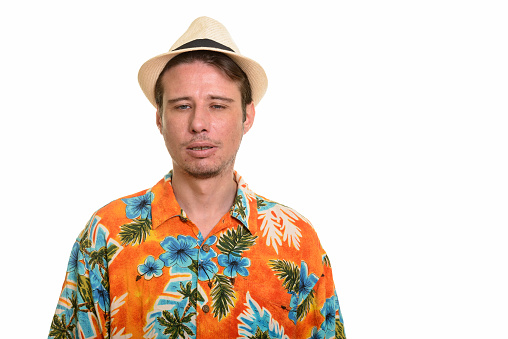 Close up of stressed tourist man looking tired ready for vacation horizontal shot