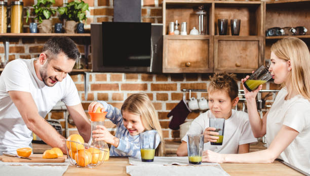 istock Family makes orange juice 668631086