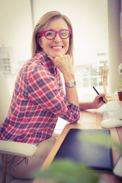 istock Casual designer working and smiling at camera 668638180