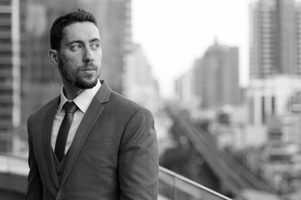 istock Young handsome businessman thinking and looking back at rooftop in Bangkok Thailand 668641090